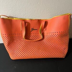 Guess Convertible Hobo Bag in coral and‎ yellow.